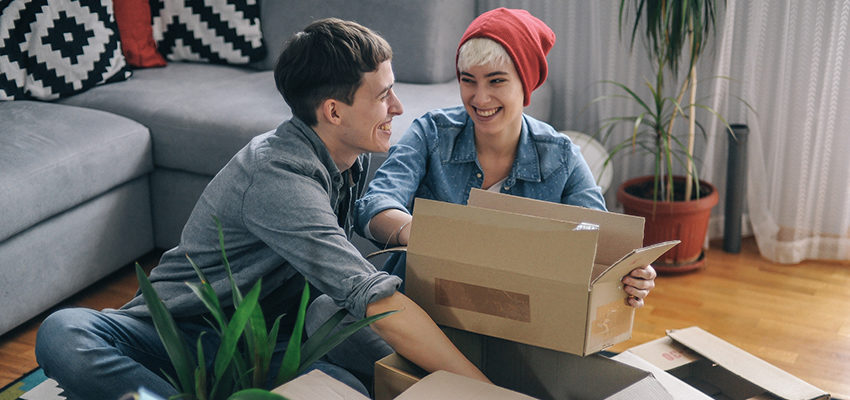 couple smiling while packing