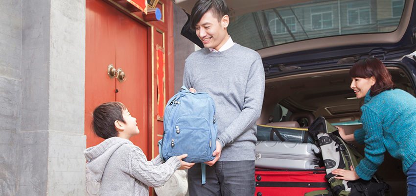 family packing bags in car