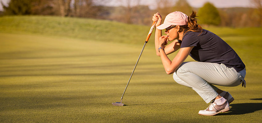 woman concetrating in golf