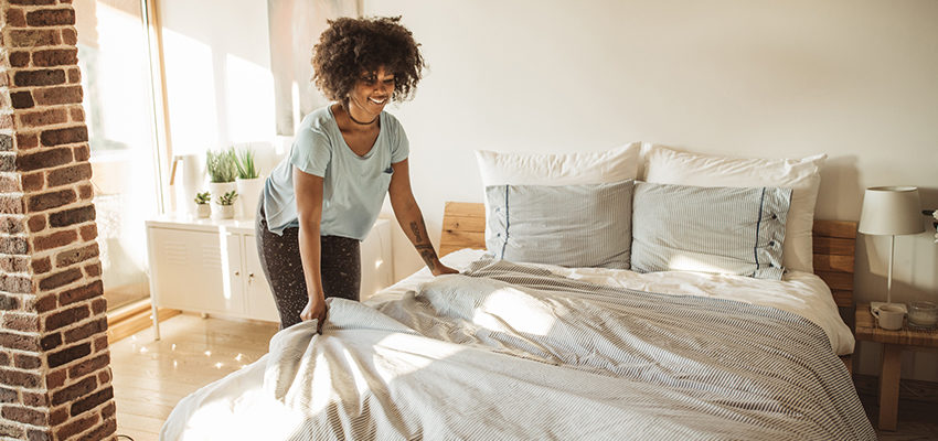 Woman makes a bed