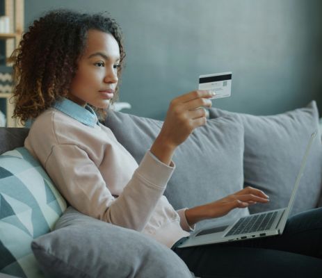 Person with credit card and laptop